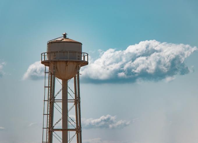 A water tower against a cloudy sky