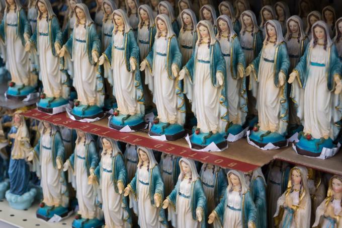 Shelves full of small statues of the Virgin Mary