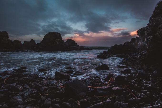 A rocky ocean edge at dusk