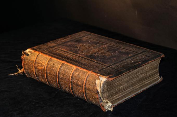 Old, leather bound book on a dark background