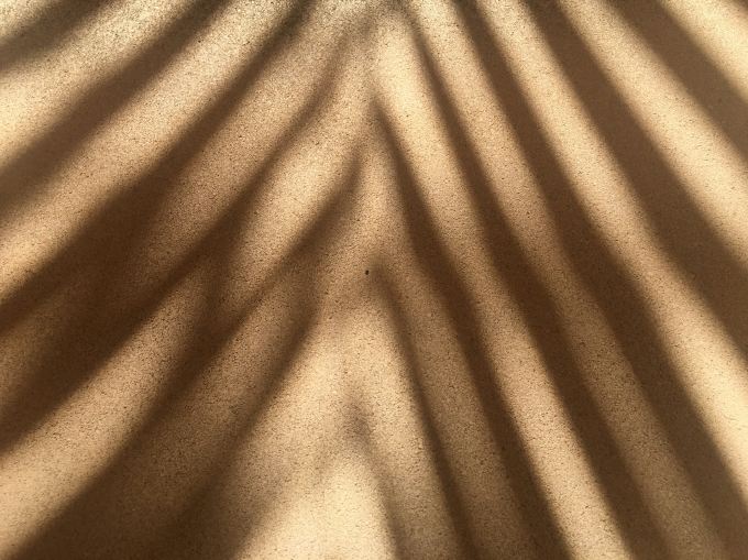Streaky shadow along a beige wall