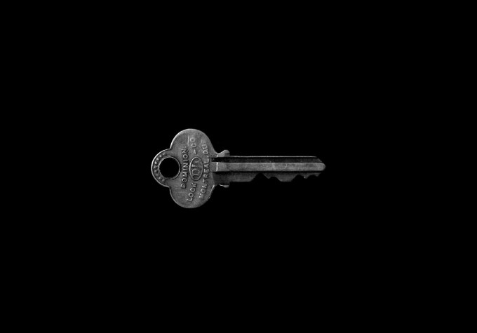 Gray key against a black background